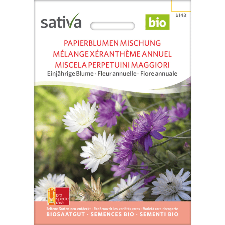Frøpose med økologiske papirblomster i blandede farver, mærket "sativa bio", med tekst på flere sprog.