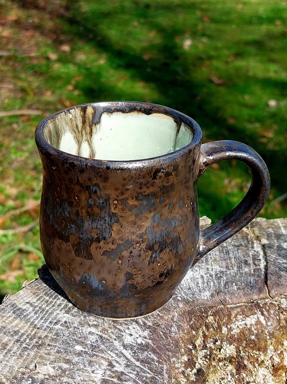 Kop med hank i sort mat glasur med guld effekt   