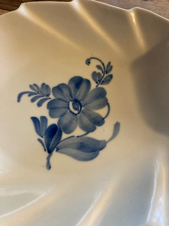 Tallerken med bølget kant og blå blomsterdekoration på hvid porcelæn. (3)