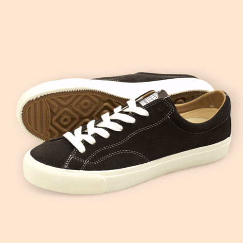 Sort sneakers med hvide snørebånd og sål, med ruskindsoverflade og mønstret gummisål. (3)