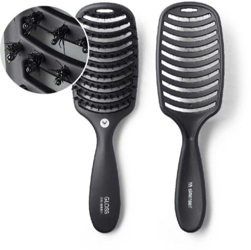 Billede af en sort ventileret hårbørste med glatte, buede børstehår og en zoom-in cirkel, der viser små hårstrå fanget mellem børstehårene.