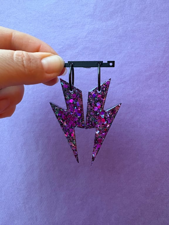 Store lyn i lilla/sort glimmer 