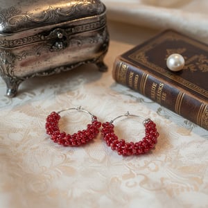 Rødefarvet perler snoet omkring creolen – produktbillede