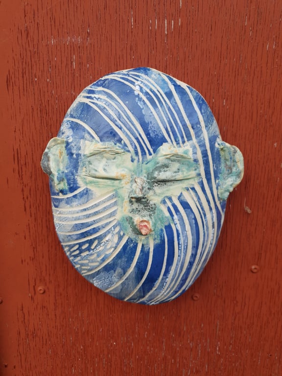 Vægkunst med ansigt, der rækker tunge