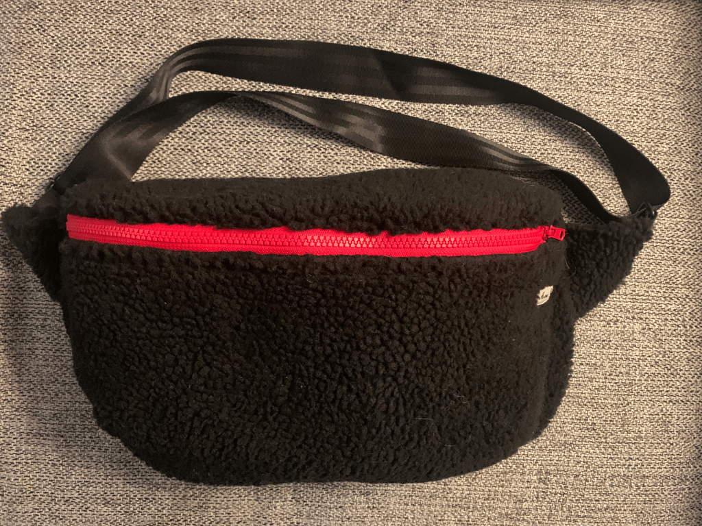 Stor bæltetaske i sort teddy med røde detaljer