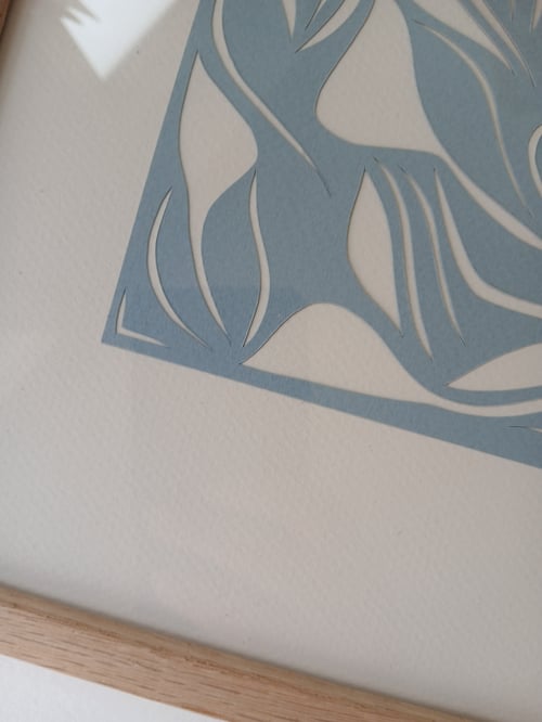 A3 papercut, lys dueblå, indrammet 