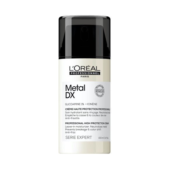 Flaske med L'Oréal Professionnel Metal DX, en professionel leave-in creme til hårbeskyttelse mod brud og farveforandring.