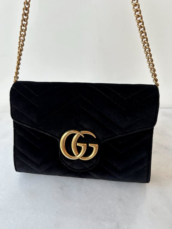 Sort Gucci skuldertaske i fløjl med guldlås og kæde.