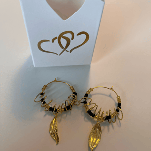 Guld og sorte perler med snoet wire omkring creolerne  – produktbillede