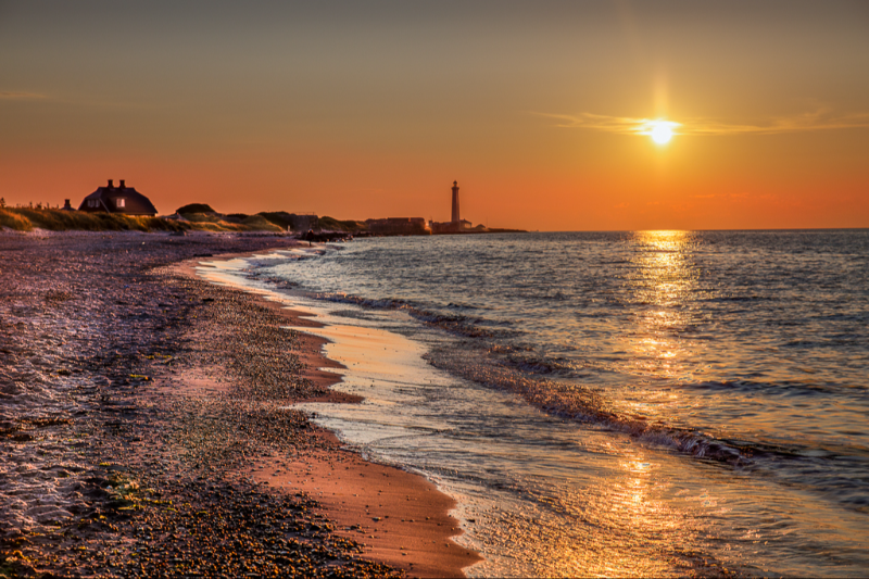 Solopgang over Skagen fyr og Sønderstrand