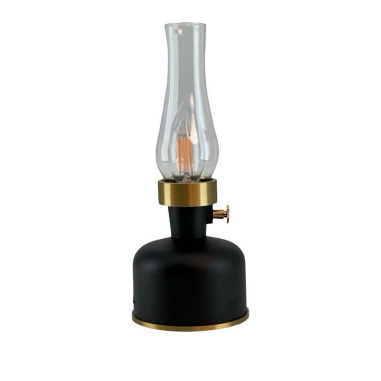 Sort og gylden lampe med transparent glas og LED-pære, designet som en moderne olielampe.